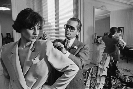 11 Apr 1983, Paris, France --- Karl Lagerfeld fits one of his designs on top model Ines de la Fressange at Chloe's Paris studio. --- Image by © Pierre Vauthey/CORBIS SYGMA
