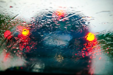 Car windshield in traffic jam during rain